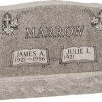 An upright custom headstone with a foundation.